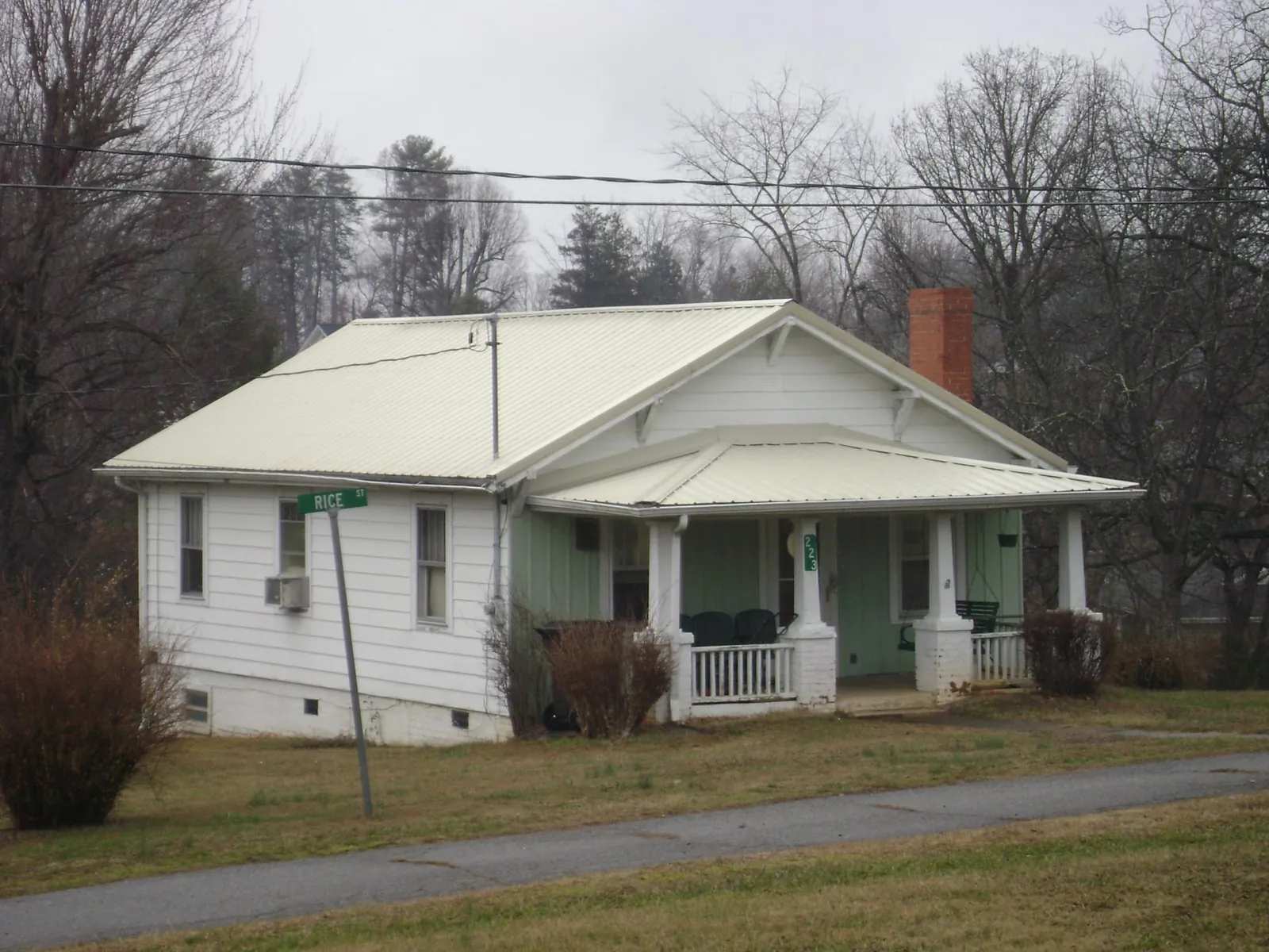 White metal roof on a craftsman bungalow at a street corner in Britt